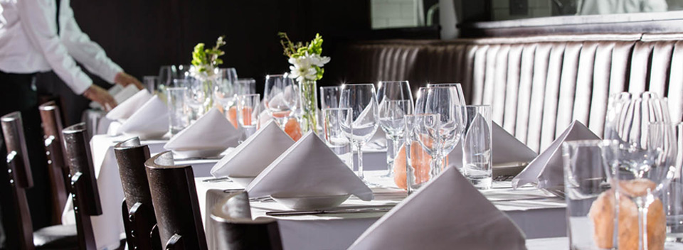 image of waiter setting linen table